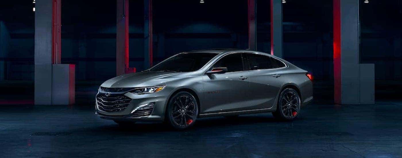 A silver 2024 Chevy Malibu Redline is shown from the side.