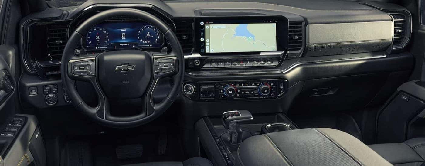 The black interior and dash are shown in a 2025 Chevy Silverado 1500 for sale.