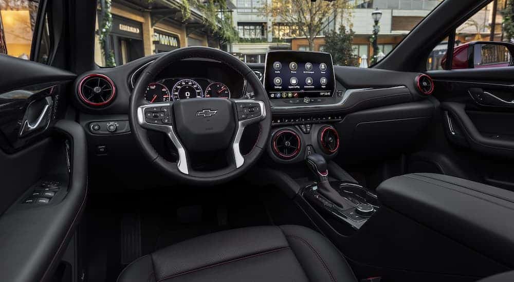 The black interior of a 2025 Chevy Blazer for sale is shown from the driver's seat.