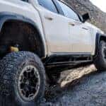 A white 2025 Chevy Colorado Trail Boss for sale near Knoxville parked uphill.