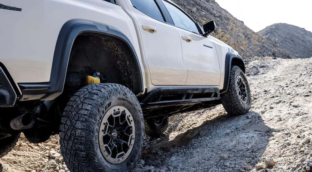 A white 2025 Chevy Colorado Trail Boss for sale near Knoxville parked uphill.