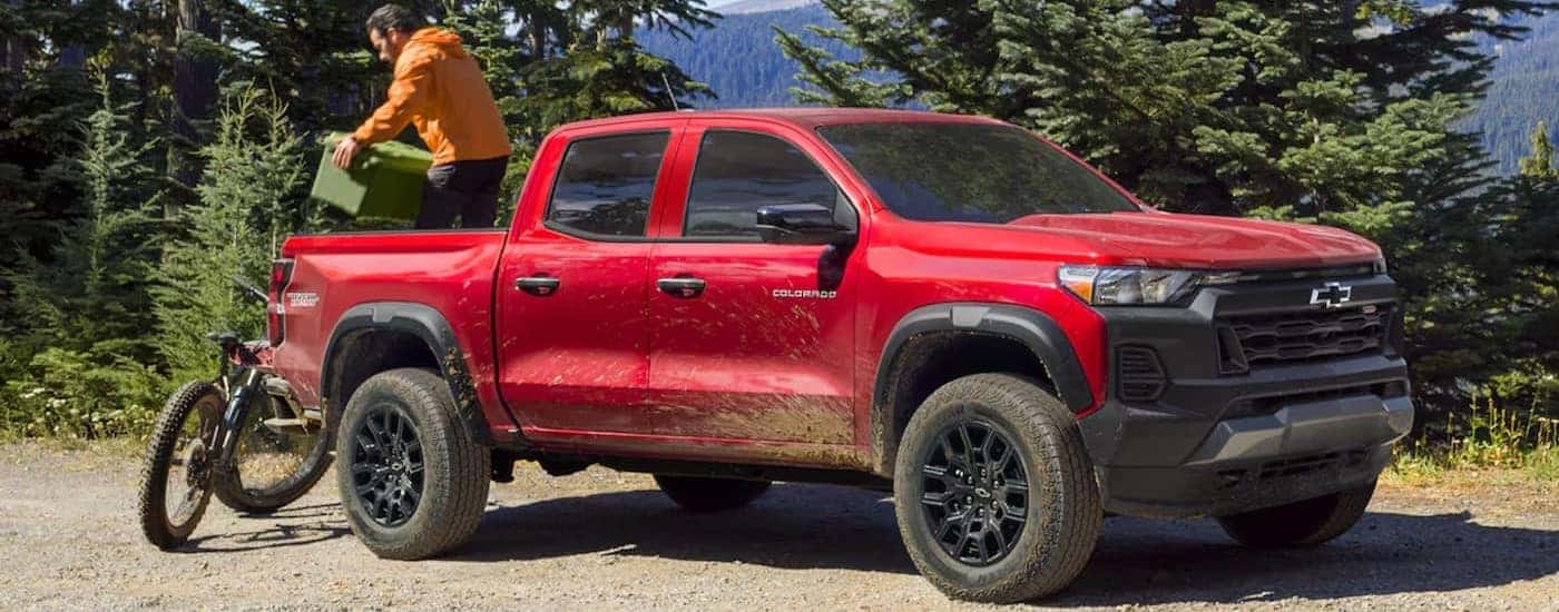 A red 2024 Chevy Colorado Trail Boss parked off-road.