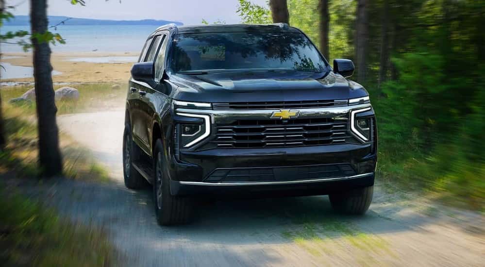 A blue 2025 Chevy Tahoe off-roading.
