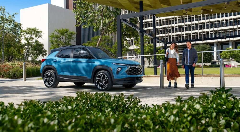 A blue 2025 Chevy Trailblazer RS parked near walking people.