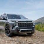 Grey 2025 Chevy Traverse Z71 off-roading on a rocky path.