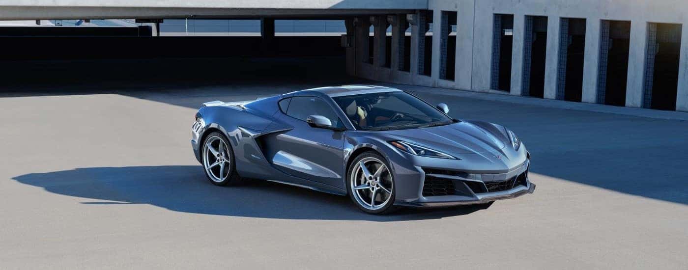 A silver 2024 Chevy Corvette E-Ray 3LZ is shown from the front at an angle after leaving a Chevrolet dealer.
