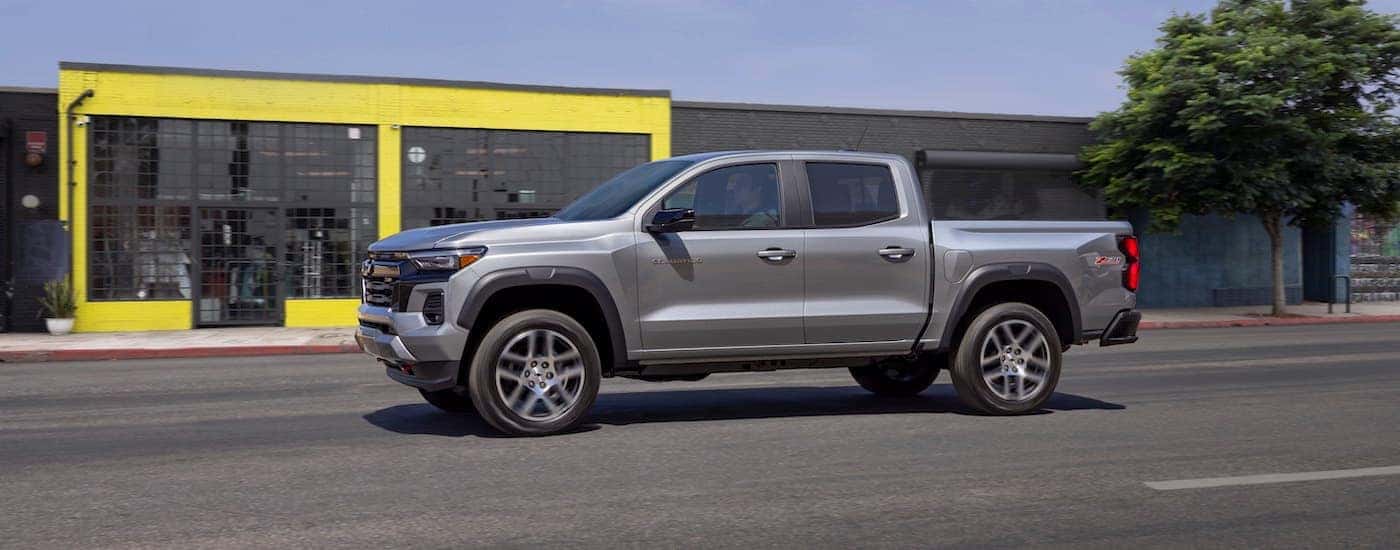 A silver 2023 Chevy Colorado Z71 is shown from the side after leaving a Chevy dealer near Karns.