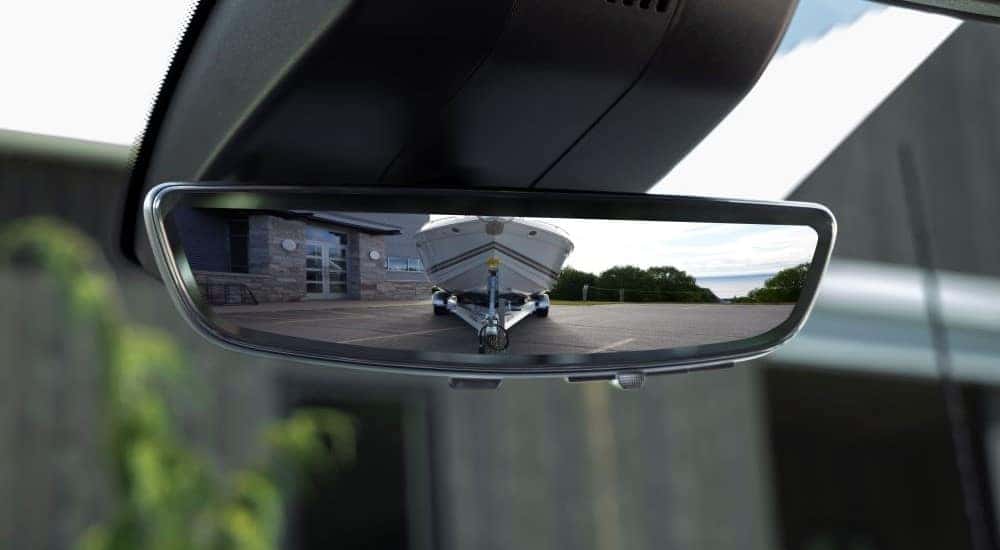 Boat in the rearview mirror of a 2025 Chevy Silverado 2500HD