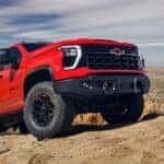 Red 2025 Chevy Silverado 2500HD ZR2 off-roading on dirt