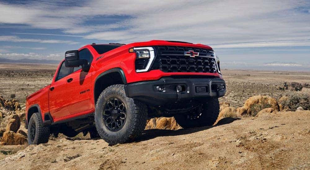 Red 2025 Chevy Silverado 2500HD ZR2 off-roading on dirt
