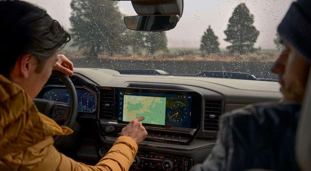 Man using map infotainment feature in a 2025 Chevy Silverado 1500