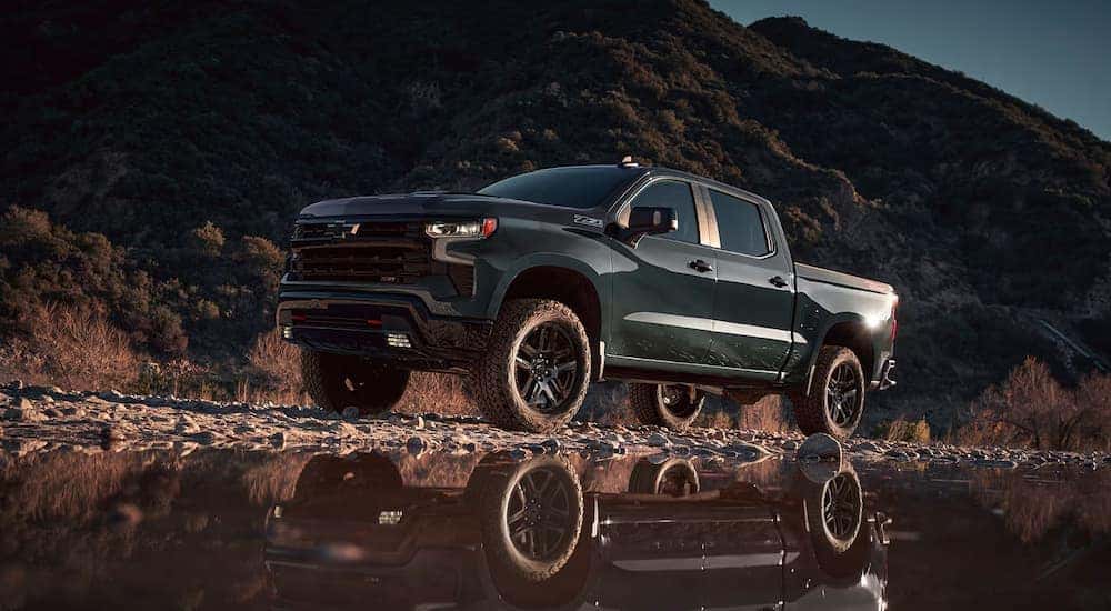 Green 2025 Chevy Silverado 1500 Z71 off-roading on a dirt road