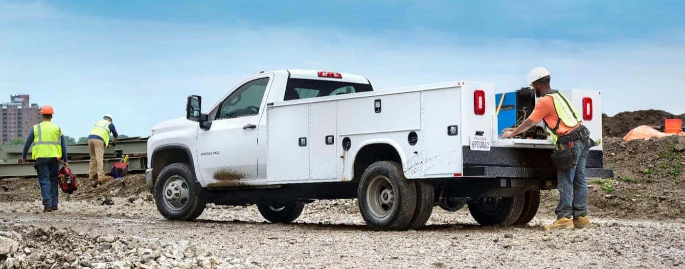 A white 2024 Chevy Silverado 3500 HD parked on a construction site.