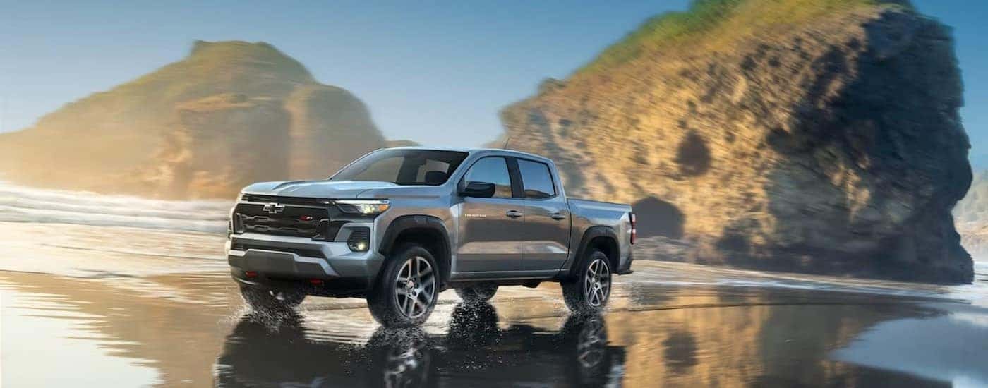A silver 2024 Chevy Colorado Z71 driving on a beach.