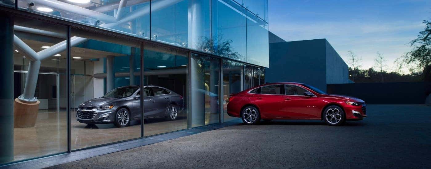 A grey and a red 2019 Chevy Malibu.