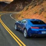 A blue 2016 Chevy Camaro from the rear at an angle after the owner searched how to 'sell my car'.