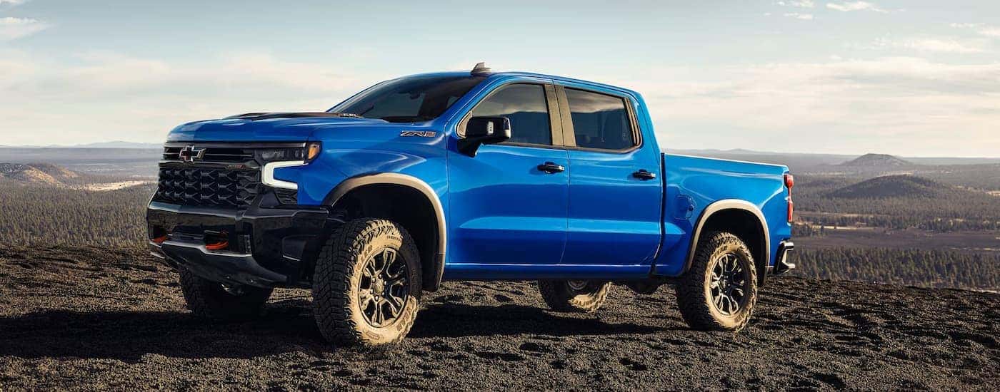 A blue 2025 Chevy Silverado 1500 parked off-road