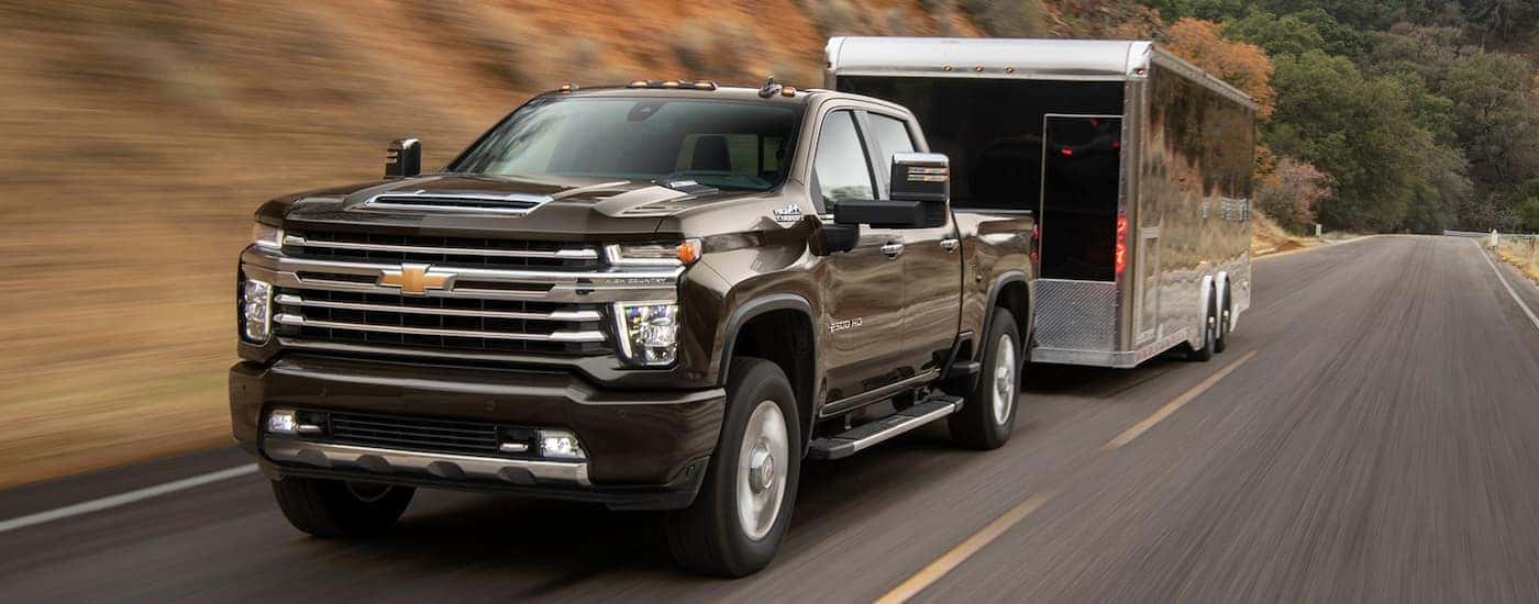 Brown 2021 Chevy Silverado 2500HD towing a black trailer
