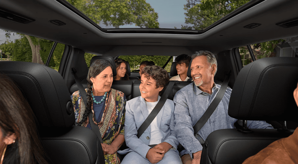 A family utilizing all three rows in a 2026 Chevy Traverse for sale