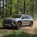 Silver 2026 Chevy Traverse RS driving down a trail