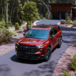 Red 2026 Chevy Traverse driving down a driveway