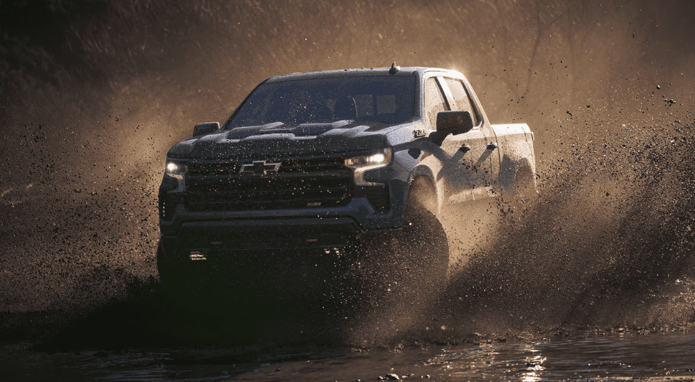 Green 2026 Chevy Silverado 1500 Z71 driving through mud