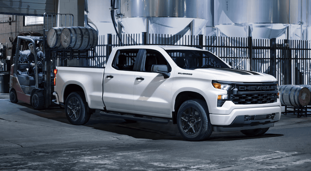 White 2026 Chevy Silverado 1500 Rally Edition loading the bed