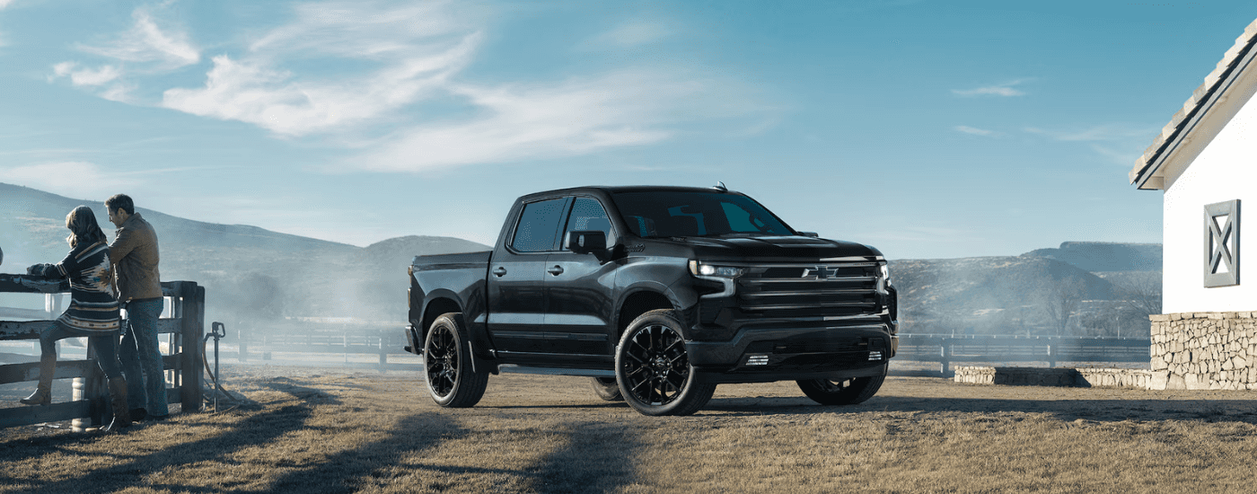 Black 2025 Chevy Silverado High Country parked on a farm