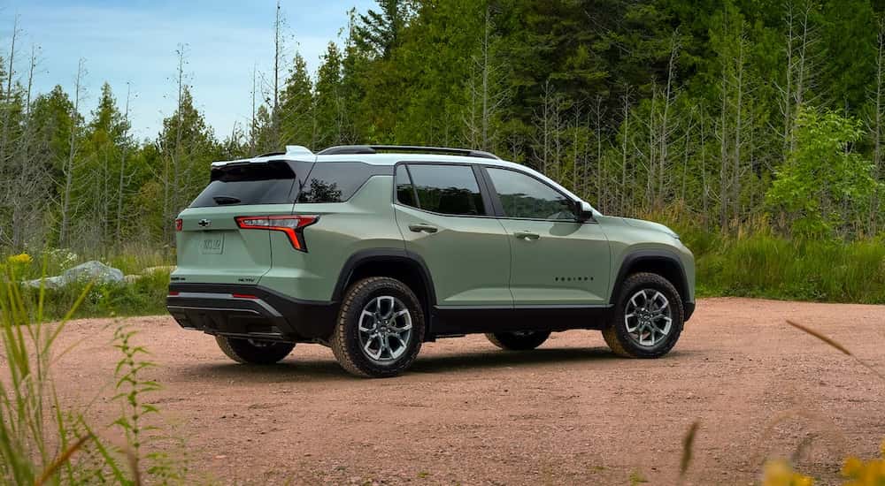 Rear of a green 2026 Chevy Equinox parked off-road.