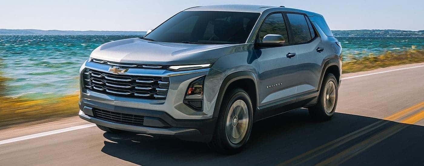 Green 2026 Chevy Equinox driving along a beach