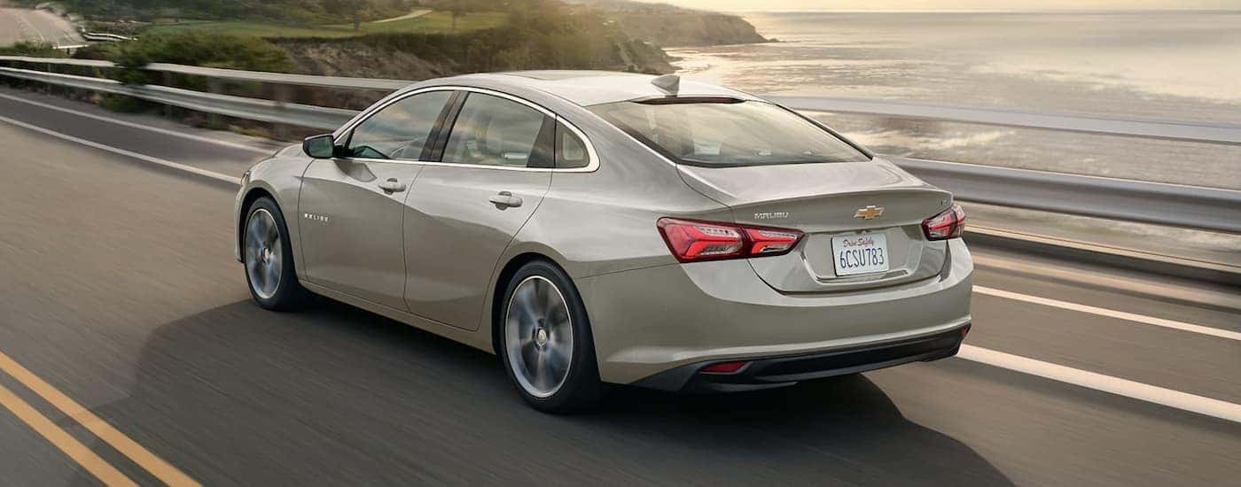 Grey 2023 Chevy Malibu driving down the road.
