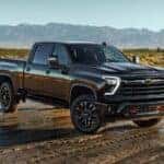 A black 2026 Chevy Silverado 2500 HD Z71 shown parked on a wet field.