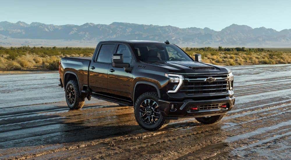 A black 2026 Chevy Silverado 2500 HD Z71 shown parked on a wet field.