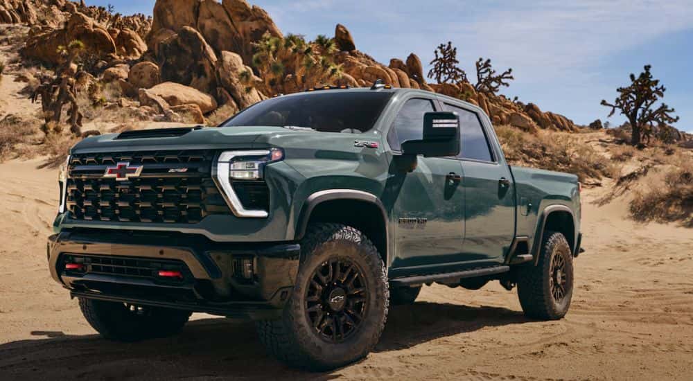 A green 2026 Chevy Silverado 2500 HD ZR2 shown parked in a desert.