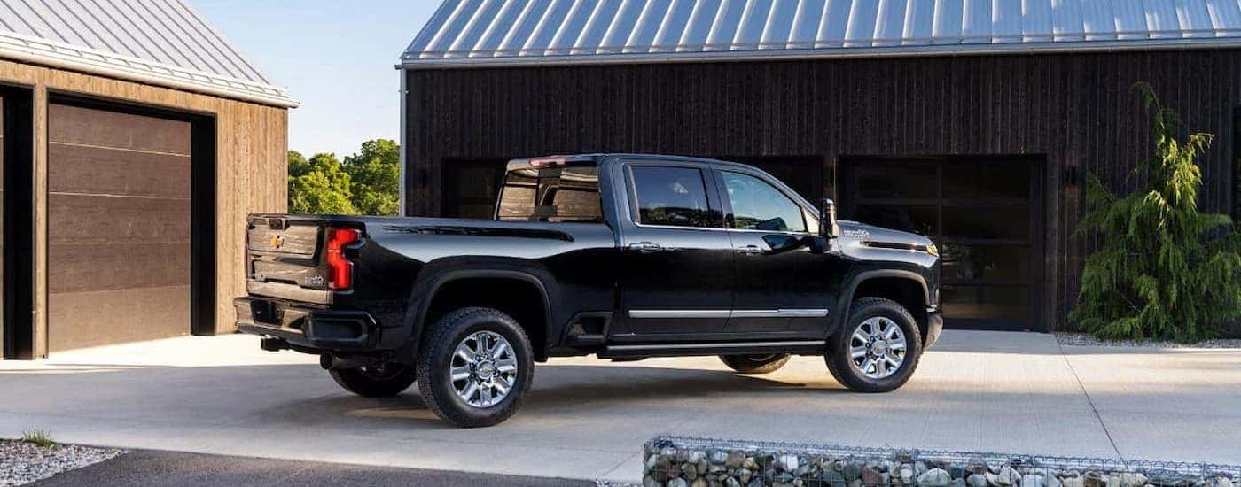 A black Chevy Silverado 2500 HD parked on a driveway.