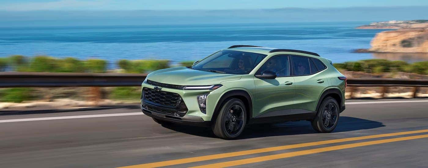 Green 2027 Chevy Trax driving down an open road.