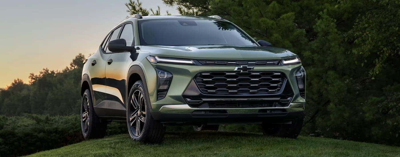 Green 2026 Chevy Trax parked off-road on a hill.