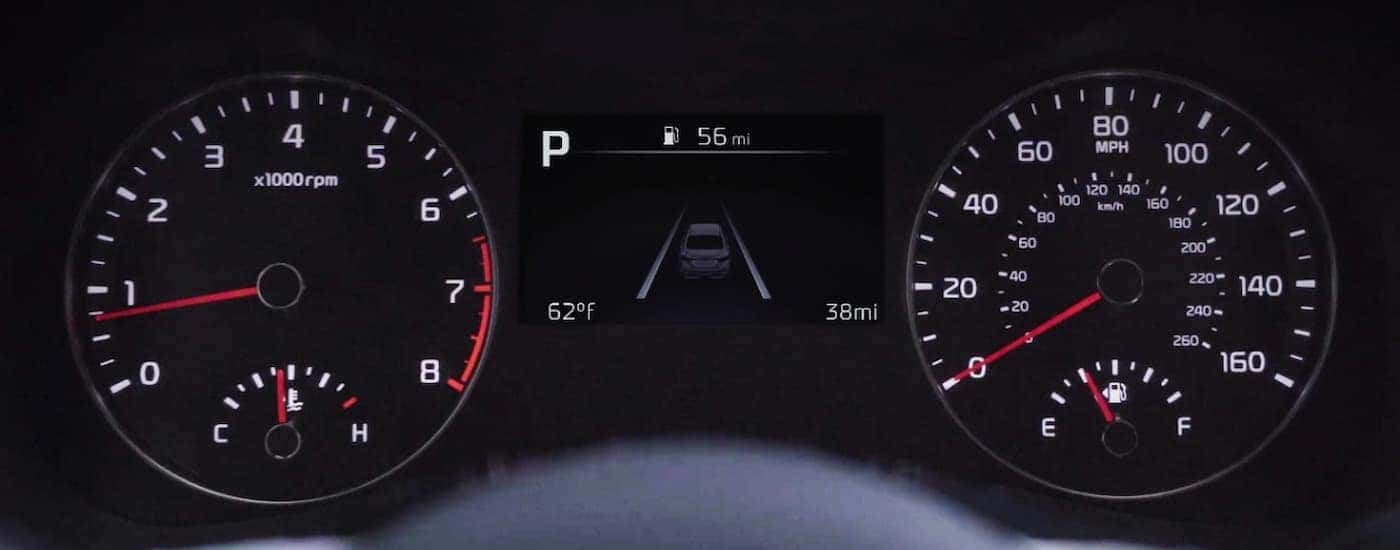 A close up of the dashboard in a 2024 Kia Forte is shown at a Kia dealer.
