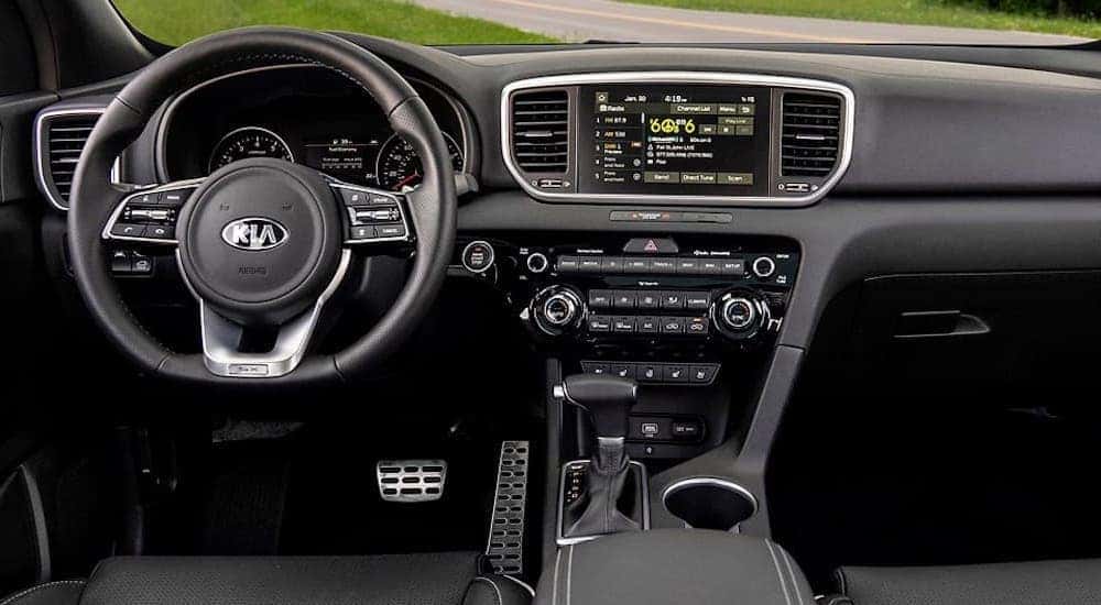 The steering wheel and dashboard inside a 2020 Kia Sportage.