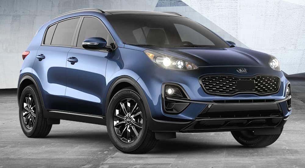 A blue 2021 Kia Sportage parked at a used Kia dealer.