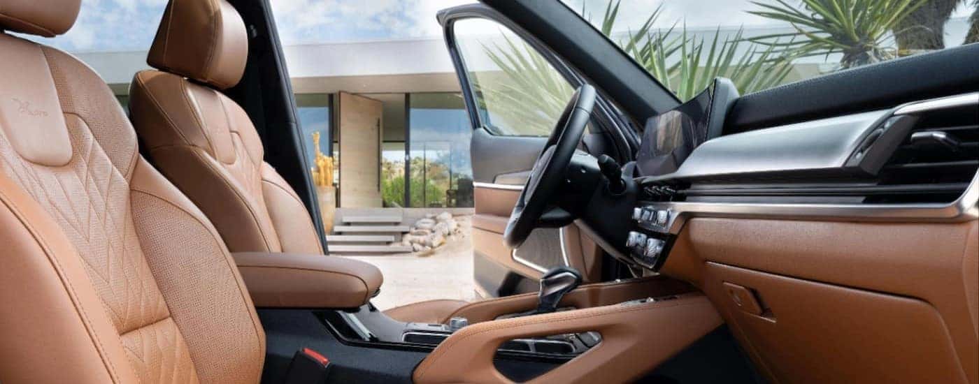 The brown front seats and dashboard in the interior of a 2024 Kia Telluride.