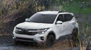 A white 2024 Kia Seltos is shown from the front at an angle after leaving a Kia dealer near Seymour.