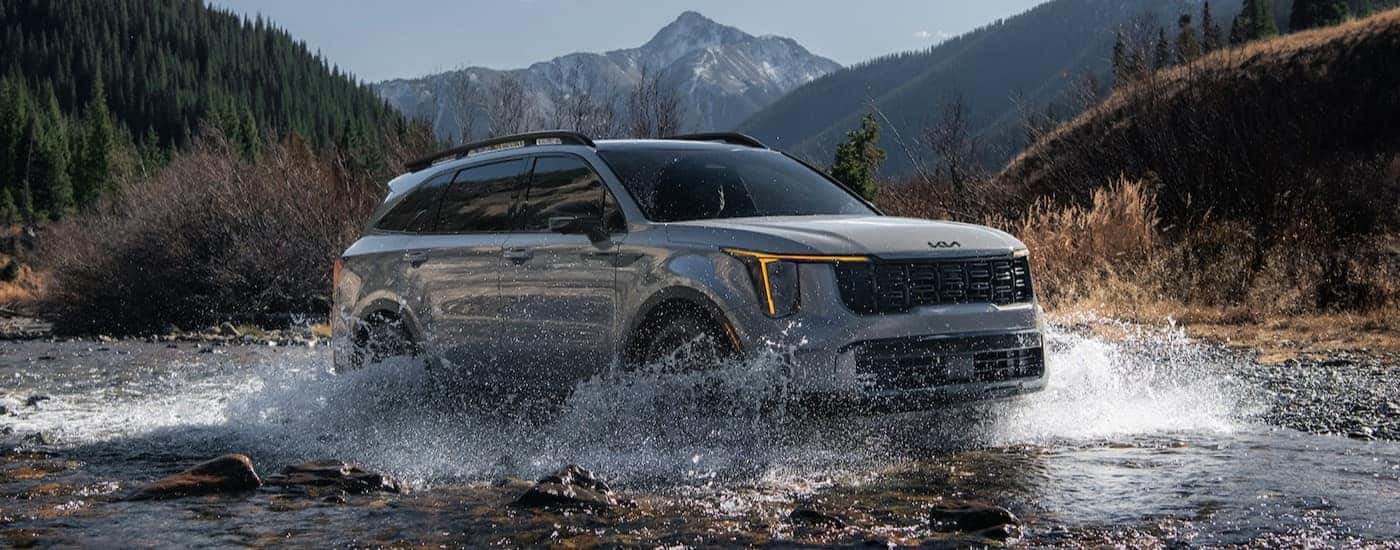 A gray 2025 Kia Sorento is shown driving on water.