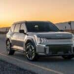 A silver 2026 Kia EV9 GT parked on an open desert road on the way to a Kia dealer near Karns.