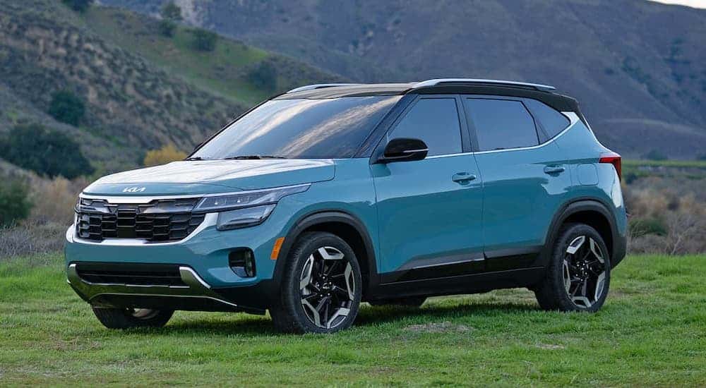 A blue 2024 Kia Seltos for sale is shown from the side.