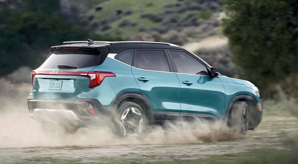 A teal 2025 Kia Seltos is shown from the side.