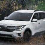 A white 2025 Kia Seltos is shown from the front..