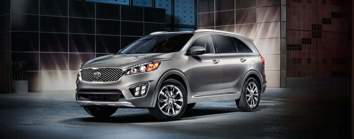 A silver 2016 Kia Sorento is shown at night.