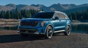 A blue 2024 Kia Sorento for sale near Oak Ridge is shown near a lake.