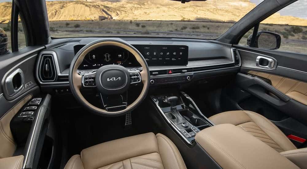 The gray and tan interior and dash are shown in a 2025 Kia Sorento.